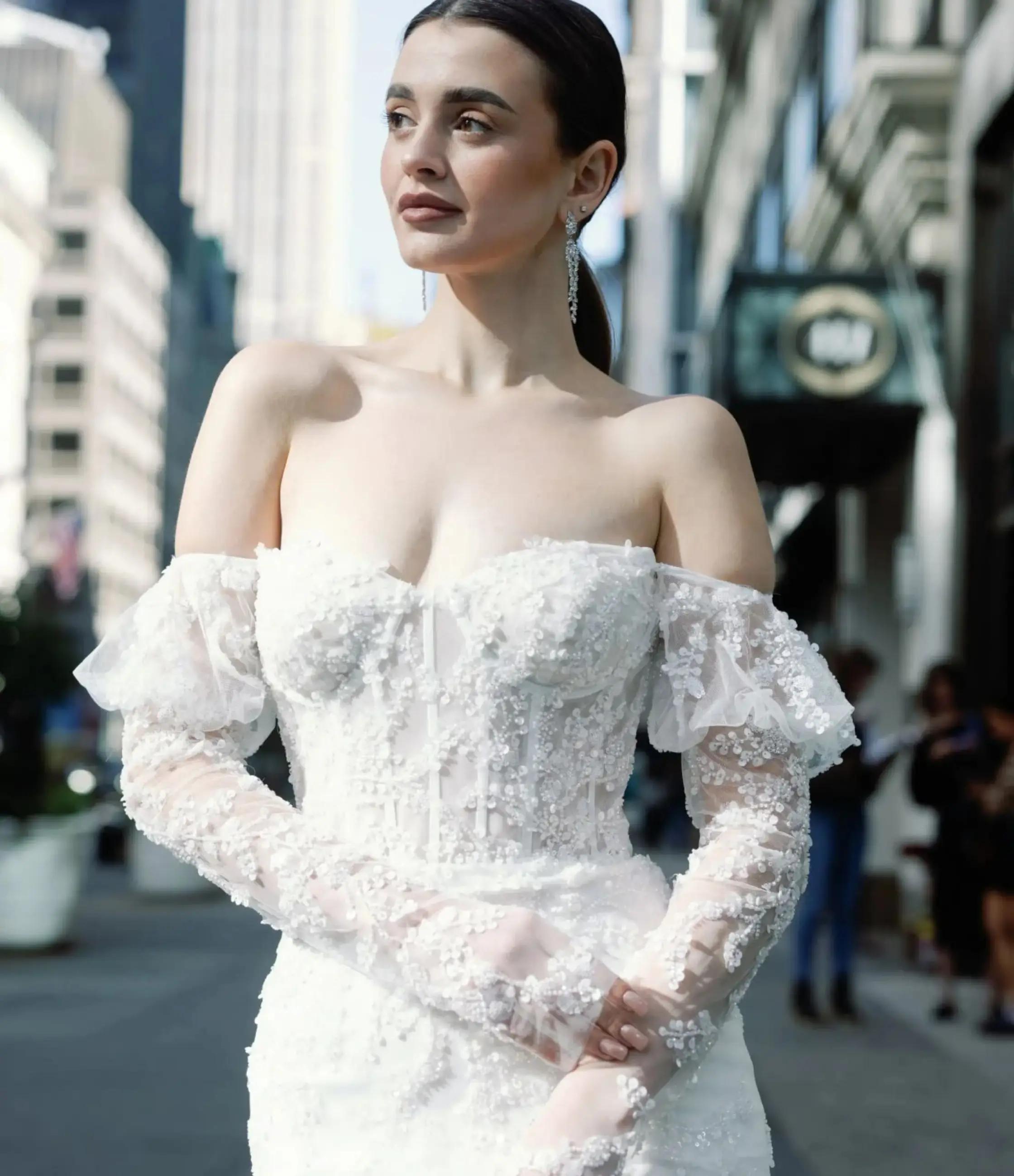 Model wearing a white gown. Mobile image